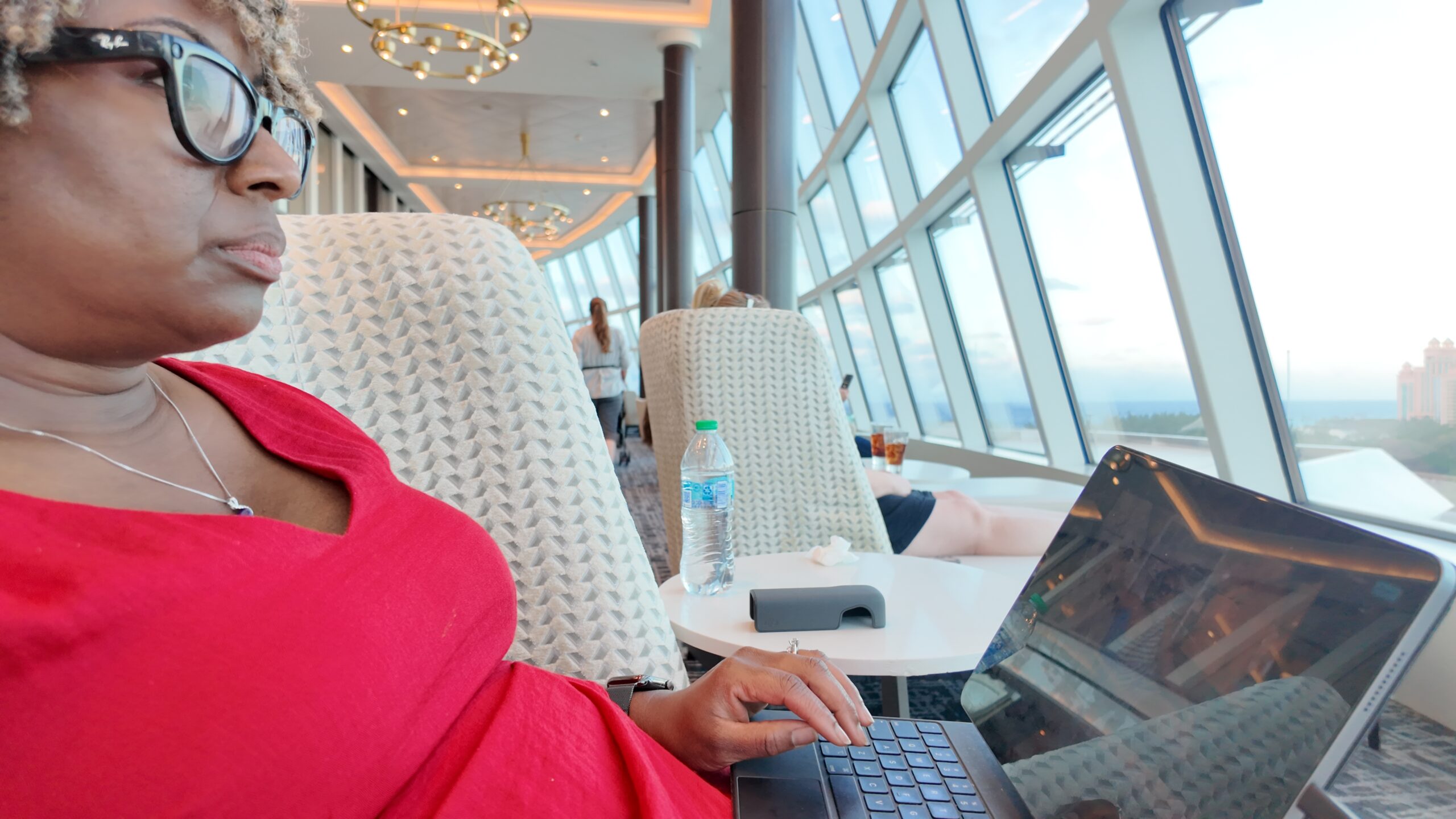 Brandi working on her laptop by a window